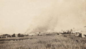 A photographic print showing the burning of the southern end of the Greenwood district from the east, about Archer and N. Trenton.