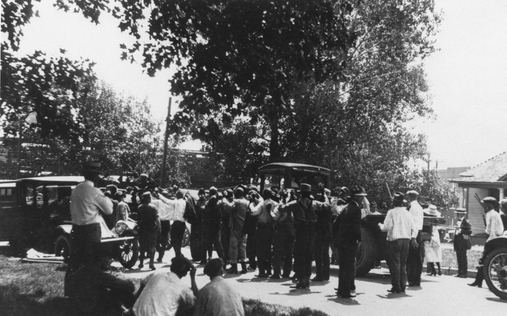 A photographic reproduction of a photo taken of people at the east side of McNulty park. "G25 of 28" written on back (struck out). Title written on front.
