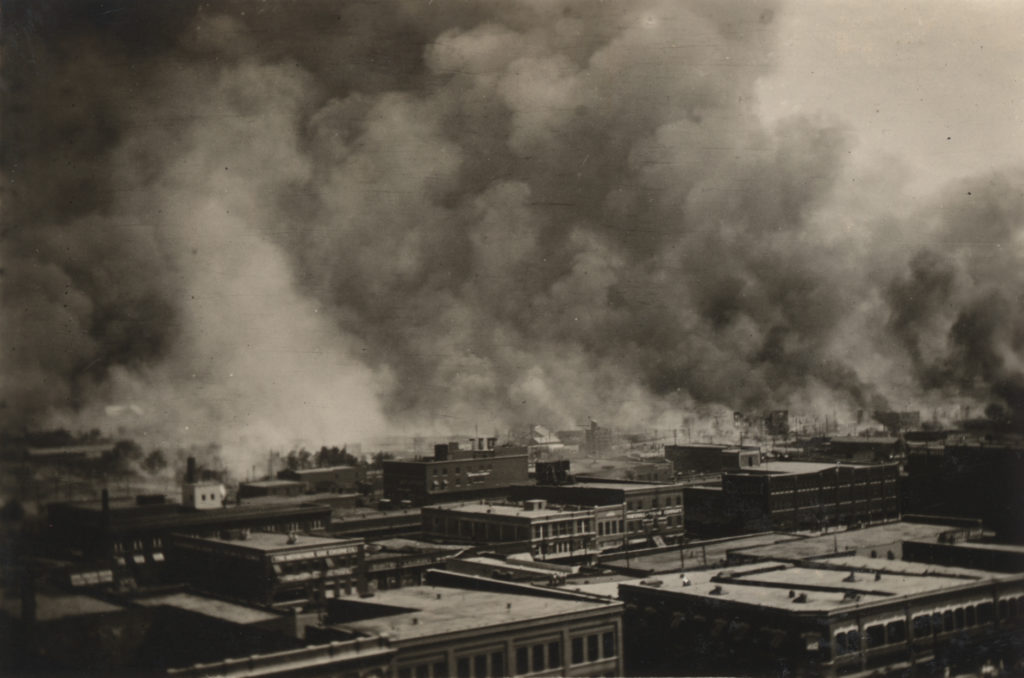 A photographic print showing the scene from the roof of the Hotel Tulsa on 3rd St. between Boston Ave. and Cincinnati Ave.. The first row of buildings is along 2nd St.