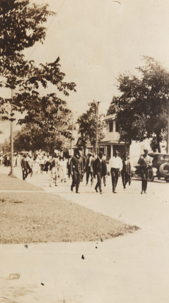 Groups of African-American men being rounded up and marched through town during the Tulsa Race Riots.