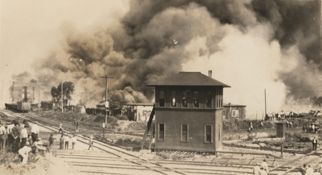 Photograph of the Tulsa railroad yard on fire.